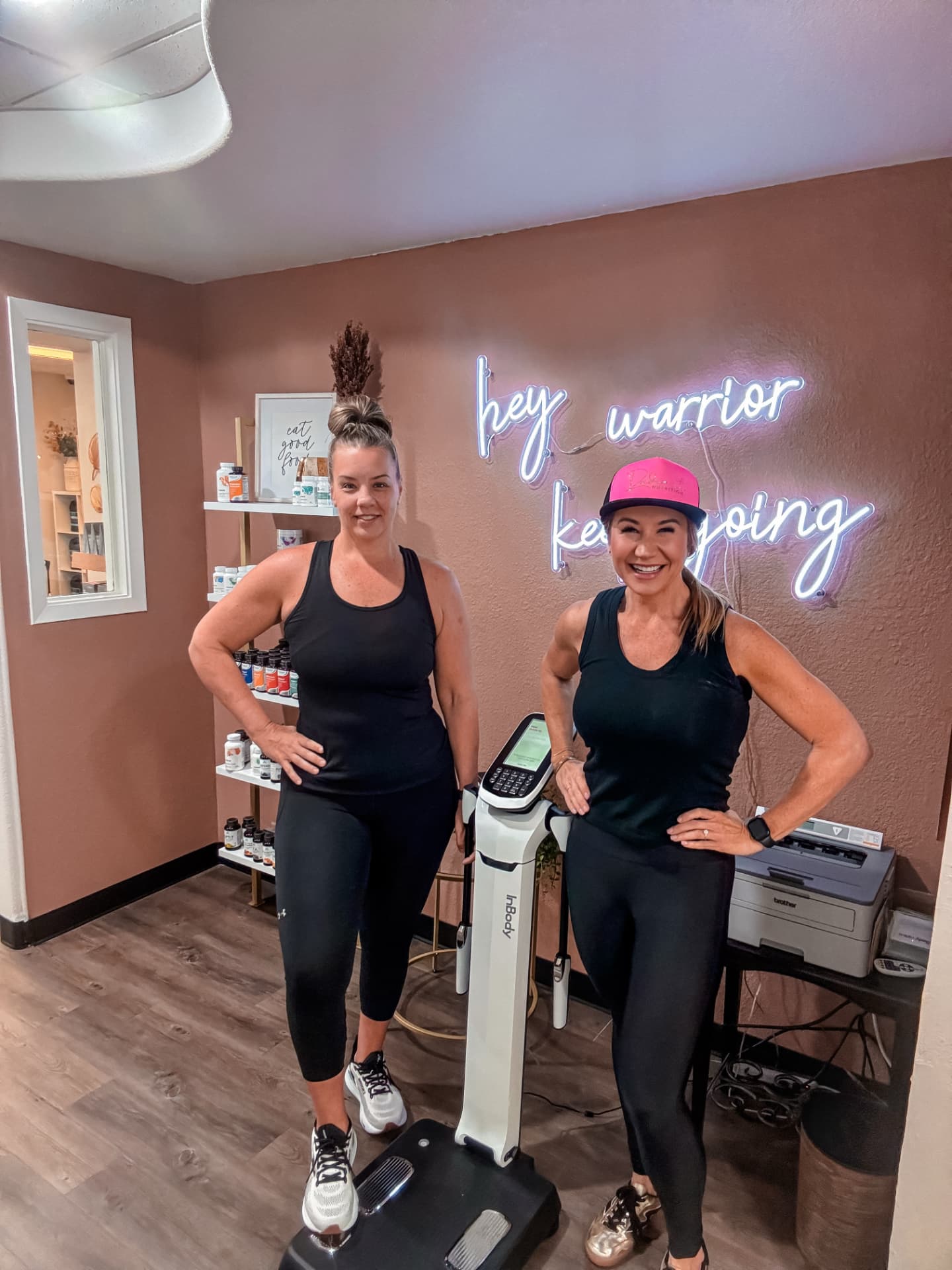 Janna Weaver and a client posing beside an InBody machine