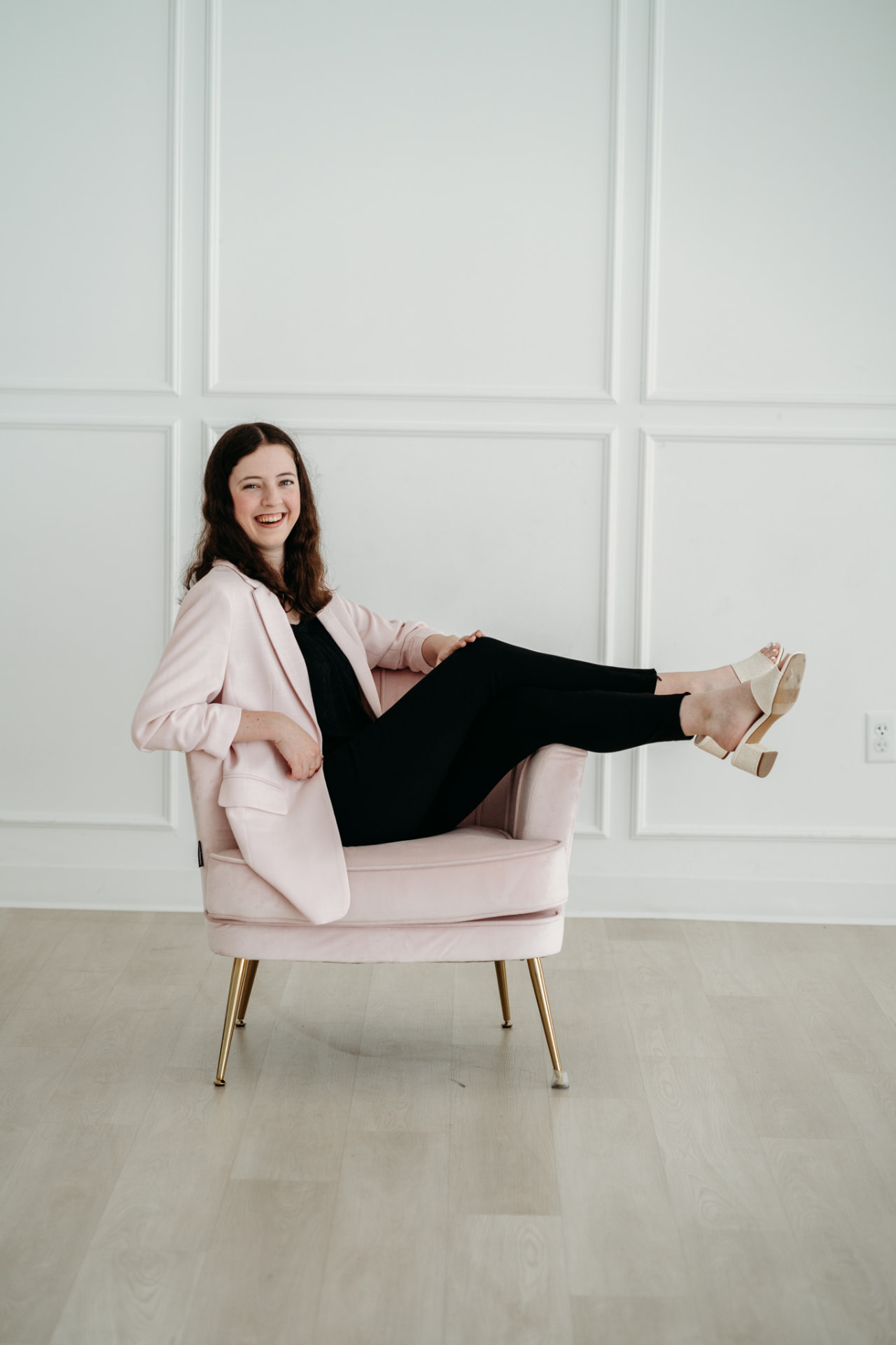 Sabrina relaxing in a pink chair