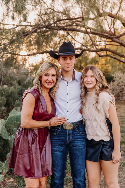 Janna Weaver with her two children outdoors at sunset
